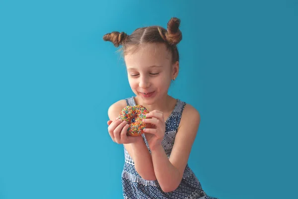 Chica con rosquilla de chocolate. Sonríe . —  Fotos de Stock