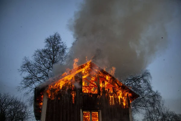 Old wooden house on fire.