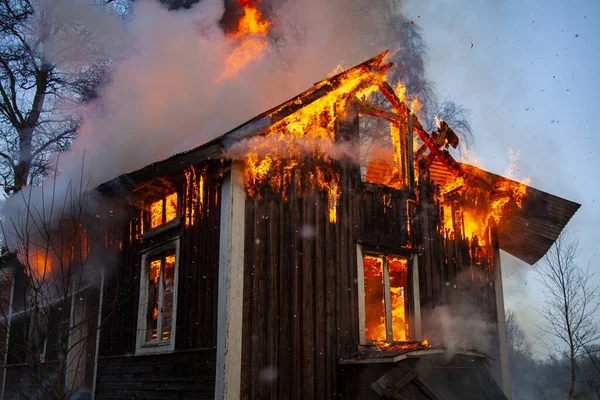 Old wooden house on fire.