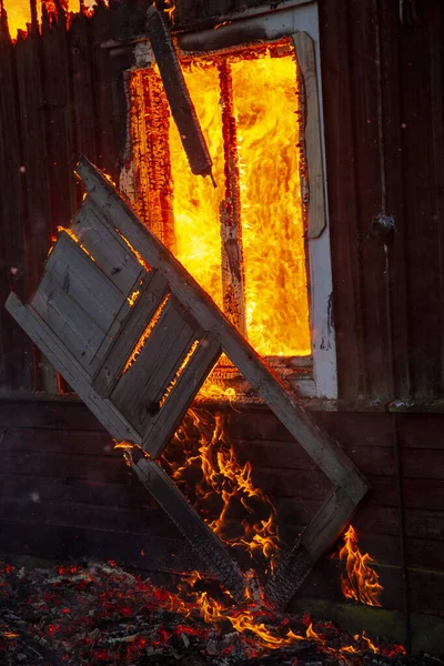 Old wooden house on fire.