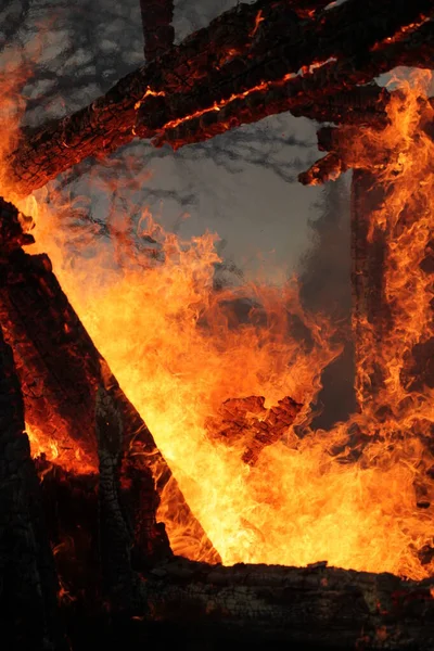 Old wooden house on fire.