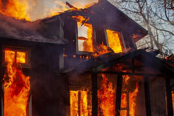 Old wooden house on fire.