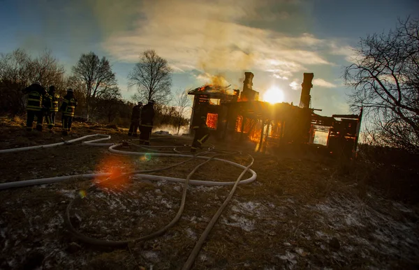 Old wooden house on fire.