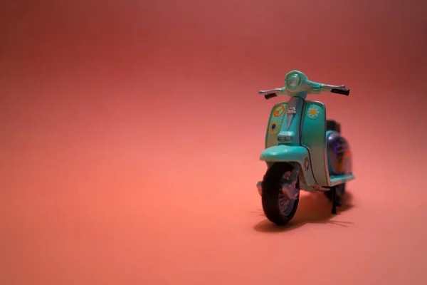 minimalist toy bike on pink background