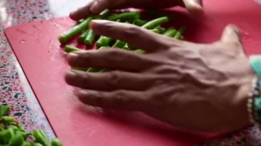 Şef öğle yemeğinde mutfakta yeşil fasulye düzenliyor.