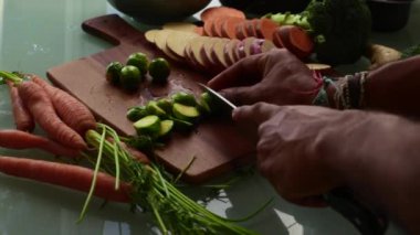 Tahta kesme tahtasında taze sebze doğramak.