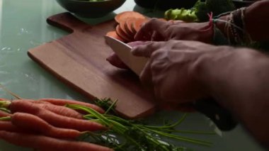 Tahta kesme tahtasında sebze dilimlemek.