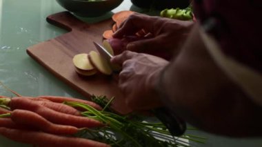 Tahta kesme tahtasında sebze dilimlemek.