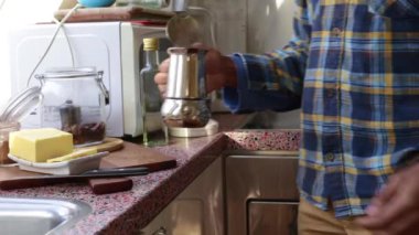 Low view person making bulletproof coffee in the morning