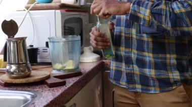 Low view person making bulletproof coffee in the morning