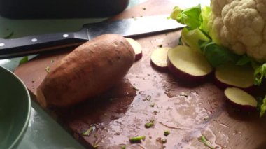 Dilimlenmiş patates ve yeşil marul yaprakları.