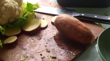 Adam çeşitli sebzeleri pişirmek için hazırlıyor.