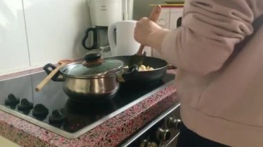 Eletric sobada tavuk kızartan genç bayanı kapatın.