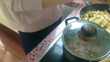 Eletric sobada tavuk kızartan genç bayanı kapatın.