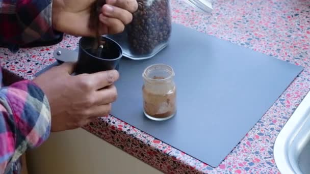 Person Manually Grinding Roasted Coffee Beans Home — Stock Video