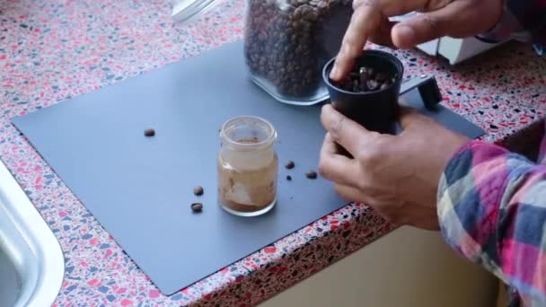 Person Manually Grinding Roasted Coffee Beans Home — Stock Video