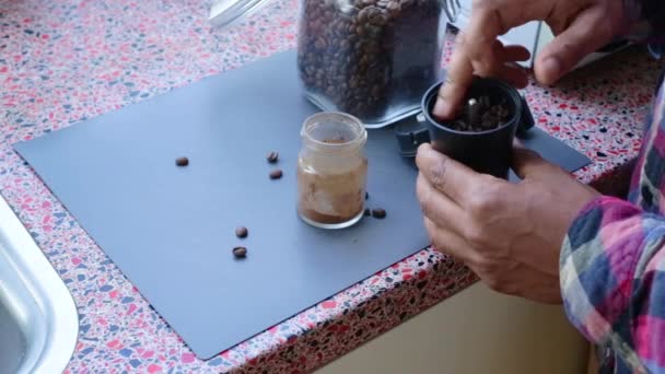 Person Manually Grinding Roasted Coffee Beans Home — Stock Video