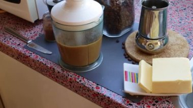Man making nutricious coffee with butter