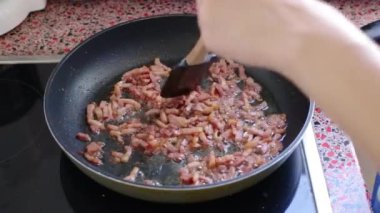 Mutfakta lezzetli carbonara makarnası için domuz pastırması kızartma şefini kapat.