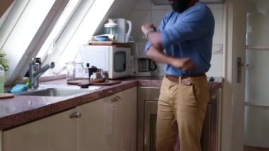 Man making espresso coffee with moka pot at home