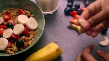 İnsan elleri kahvaltı için lezzetli müsli hazırlıyor.