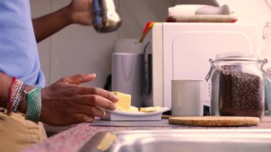 Person making bulletproof coffee with butter and MCT oil at home 