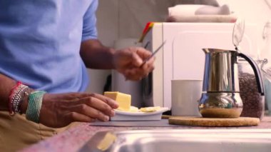 Person making bulletproof coffee with butter and MCT oil at home 