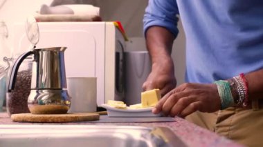 Person making bulletproof coffee with butter and MCT oil at home 