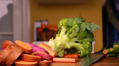 Evde sebzelerle sağlıklı yemek hazırlayan kişi.