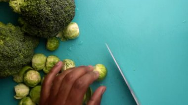 chef preparing brussel sprouts and broccoli