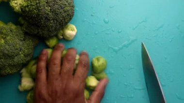 chef preparing brussel sprouts and broccoli