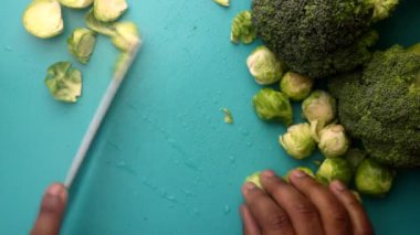 chef preparing brussel sprouts and broccoli