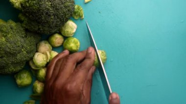 chef preparing brussel sprouts and broccoli