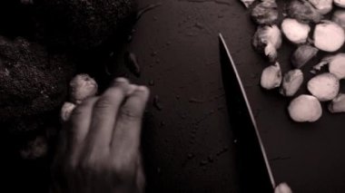 chef preparing brussel sprouts and broccoli black and white 