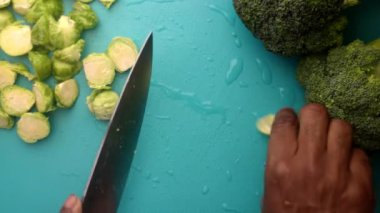 chef preparing brussel sprouts and broccoli