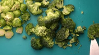 chef preparing brussel sprouts and broccoli