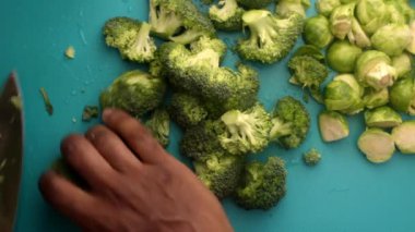 chef preparing brussel sprouts and broccoli