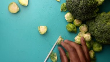chef preparing brussel sprouts and broccoli