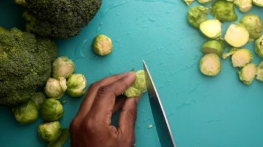 chef preparing brussel sprouts and broccoli