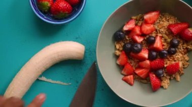 Sağlıklı müsli gevreğini meyvelerle hazırlayan kişinin düz bir görüntüsü vardı.
