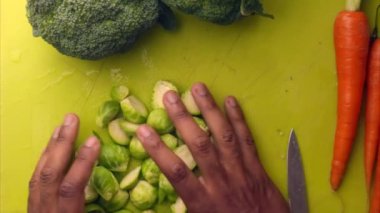 Person hands preparing organic vegetables for healthy meal in kitchen