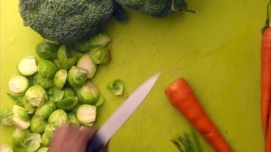 Person hands preparing organic vegetables for healthy meal in kitchen