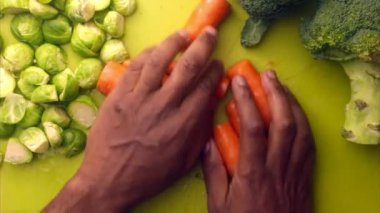 Person hands preparing organic vegetables for healthy meal in kitchen