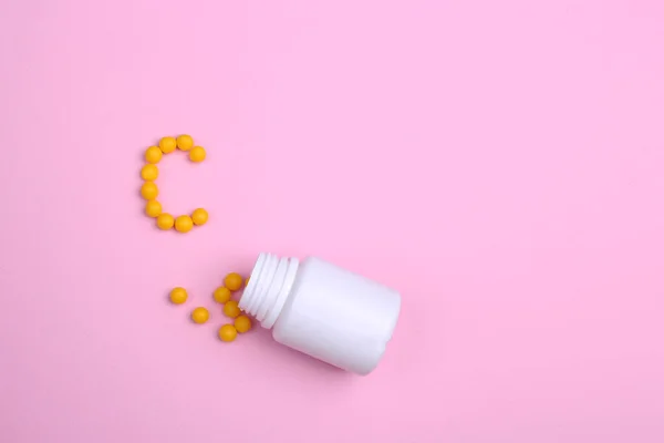 Vitaminler pembe bir zemin üzerine dağılmış, tıpkı mektuptaki gibi. 