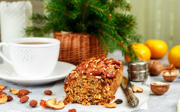Traditional Christmas fruit cake with nuts, raisins, dried fruits and spices. Christmas treat. Selective focus