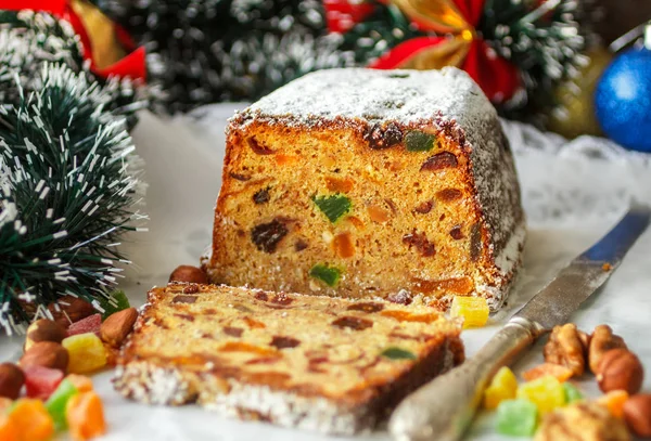 Traditional Christmas cake with nuts, candied fruit, raisins and fruits. Fruitcake. Selective focus