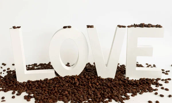 White love letters with coffee beans on white background — Stock Photo, Image