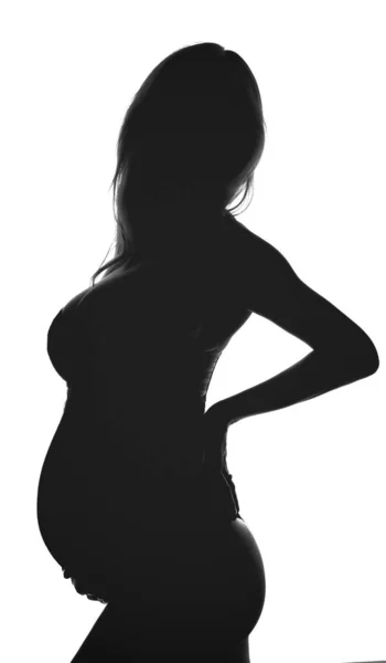 Silhouette of pregnant woman. Backlit black and white profile view Stock Picture