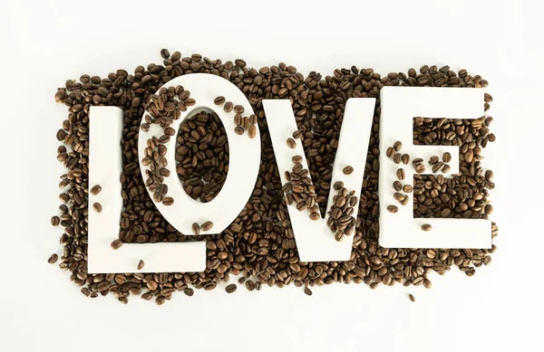White love letters with coffee beans on white background — Stock Photo, Image