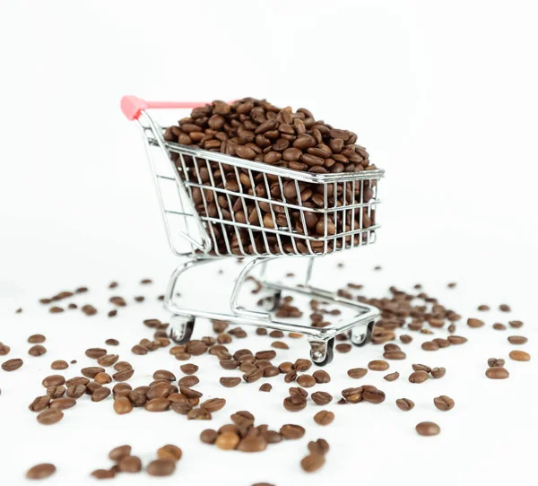 Coffee beans inside small shopping cart on white background — Stock Photo, Image